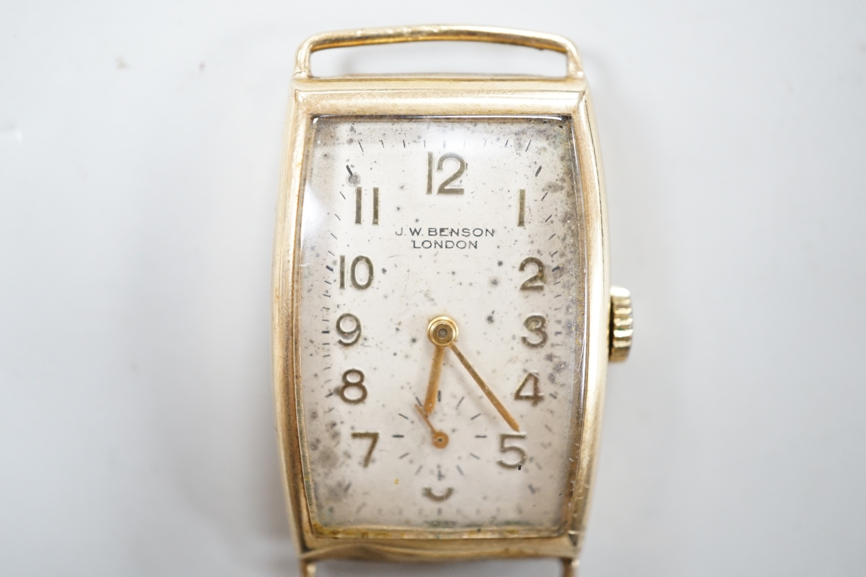 A gentleman's early 1950's 9ct gold J.W. Benson manual wind curved rectangular wrist watch, with Arabic dial and subsidiary seconds, case diameter 22mm, gross weight 16.3 grams, no strap.